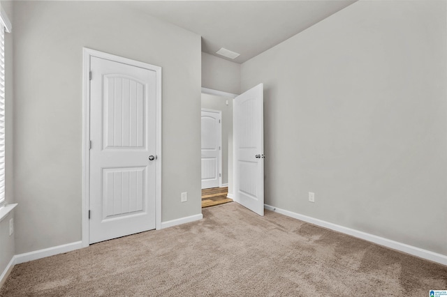 unfurnished bedroom featuring baseboards and carpet flooring