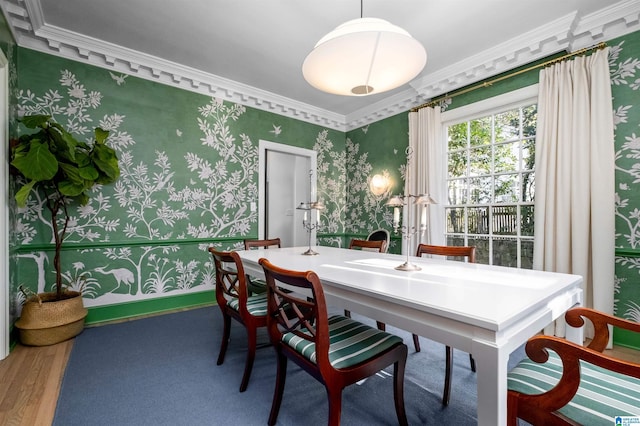 dining area featuring wood finished floors, crown molding, baseboards, and wallpapered walls