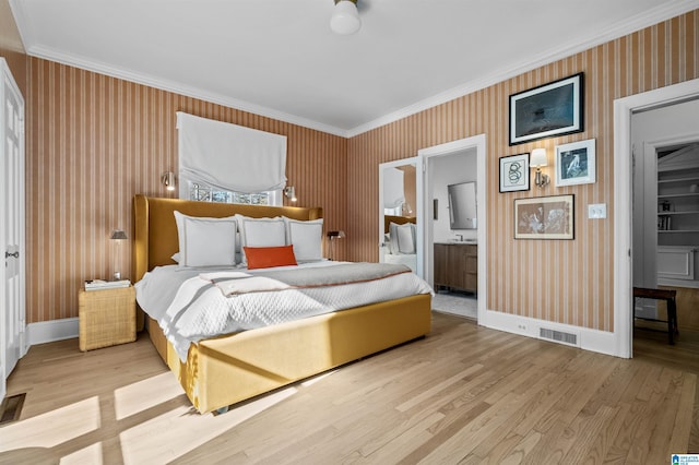 bedroom featuring visible vents, baseboards, ornamental molding, light wood-type flooring, and wallpapered walls