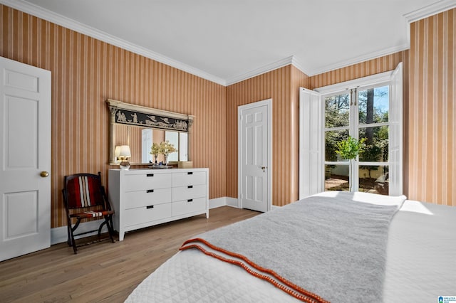 bedroom with baseboards, ornamental molding, wood finished floors, and wallpapered walls