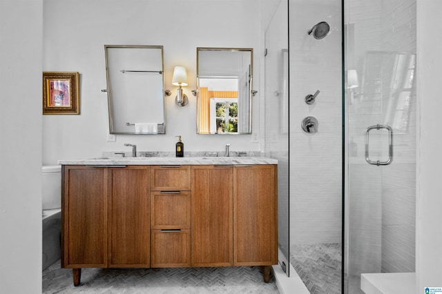 full bathroom with a stall shower, a sink, and double vanity