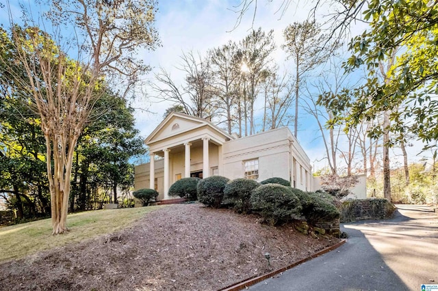 neoclassical / greek revival house featuring stucco siding