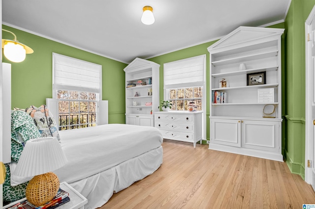 bedroom featuring crown molding and wood finished floors