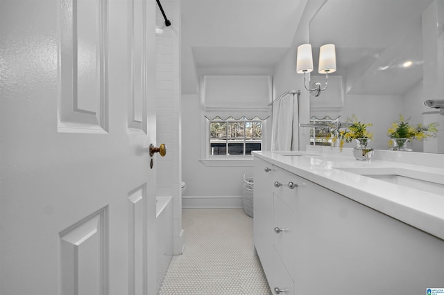 bathroom featuring baseboards, vanity, toilet, and tile patterned floors