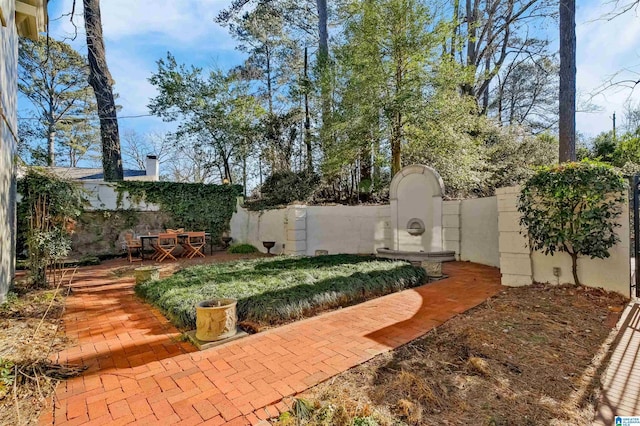 view of yard featuring fence private yard, a gate, and a patio