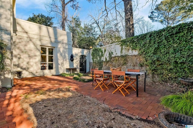 view of patio featuring fence and outdoor dining area