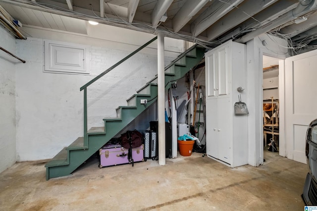 unfinished basement featuring stairway