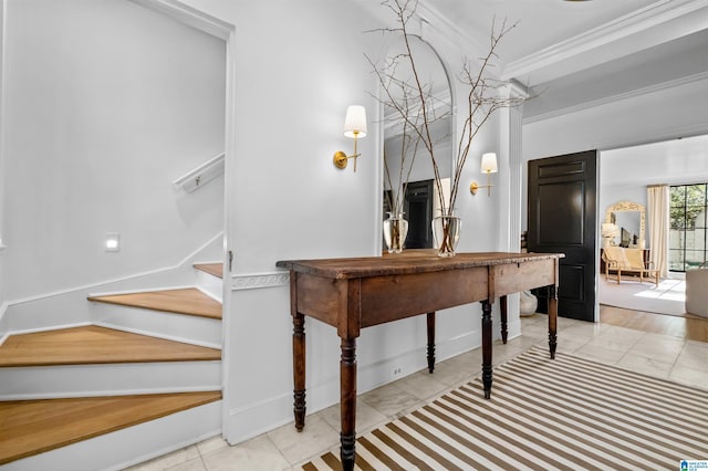 stairway with baseboards and crown molding