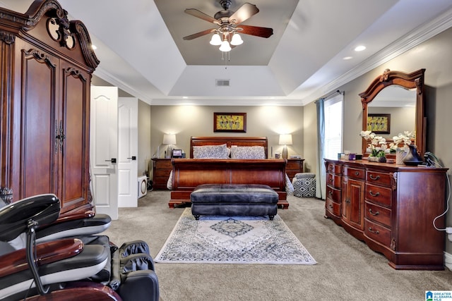 bedroom featuring light colored carpet, a ceiling fan, visible vents, a tray ceiling, and crown molding