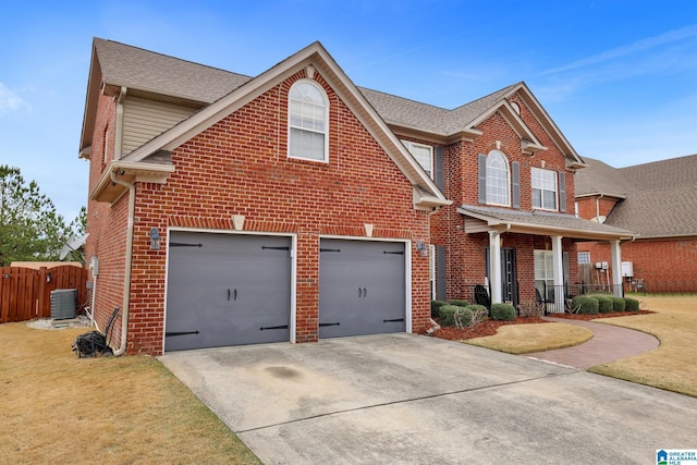 traditional-style home with concrete driveway, brick siding, fence, and central AC unit