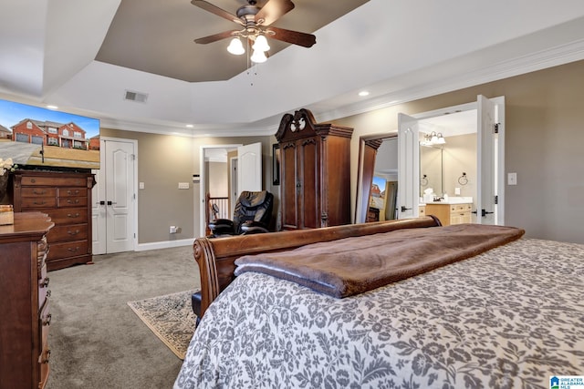 bedroom with carpet floors, visible vents, a raised ceiling, and ornamental molding