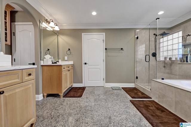 bathroom with ornamental molding, a shower stall, baseboards, and vanity