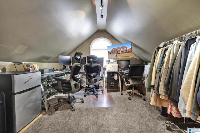 carpeted office space with lofted ceiling