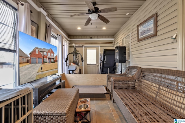 sunroom / solarium featuring wood ceiling and ceiling fan