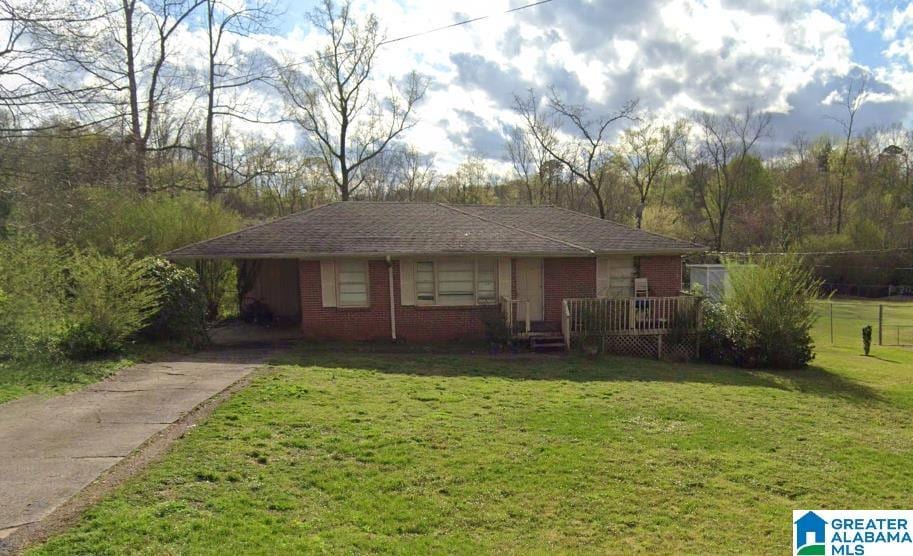 ranch-style house with a front lawn and brick siding