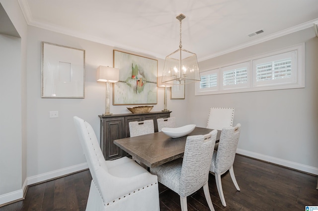 dining room featuring baseboards, dark wood finished floors, and crown molding