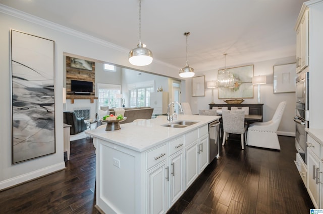 kitchen featuring dark wood-style floors, stainless steel appliances, a sink, and light countertops