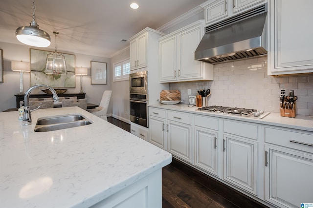 kitchen featuring stainless steel appliances, backsplash, white cabinets, a sink, and under cabinet range hood