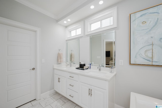 ensuite bathroom featuring double vanity, marble finish floor, a sink, and recessed lighting