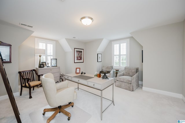 office with baseboards, lofted ceiling, visible vents, and light colored carpet