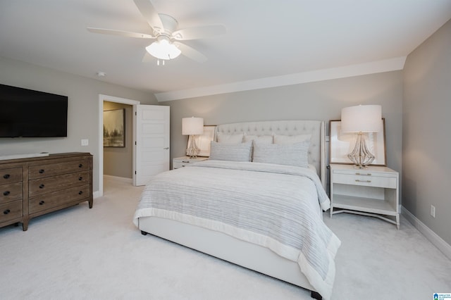 carpeted bedroom with ceiling fan and baseboards