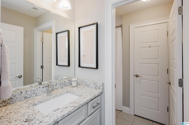 full bath featuring visible vents, baseboards, vanity, and tile patterned floors