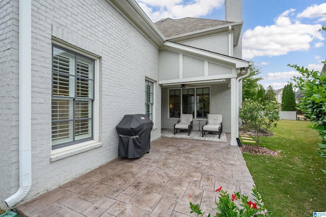 view of patio with grilling area and a ceiling fan