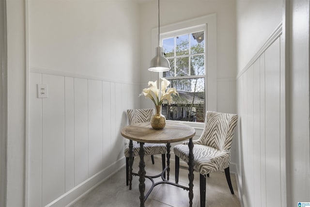 dining space featuring a wainscoted wall