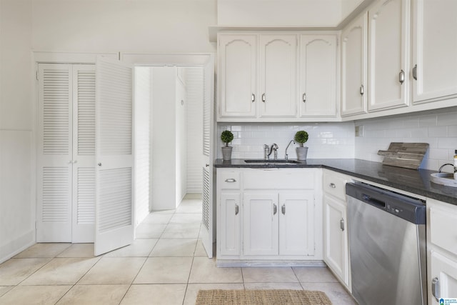 kitchen featuring a sink, light tile patterned floors, backsplash, and dishwasher