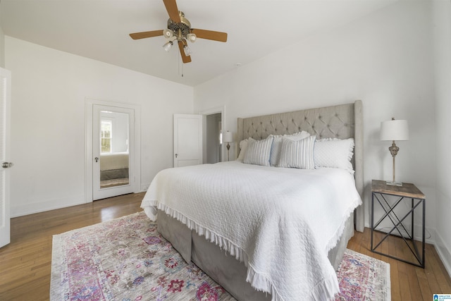 bedroom featuring ceiling fan, baseboards, and hardwood / wood-style floors