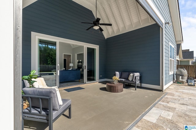 view of patio featuring a ceiling fan, fence, and an outdoor living space