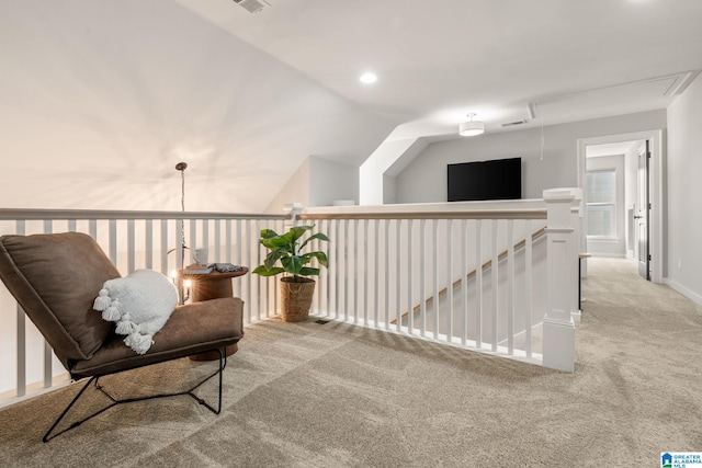 sitting room featuring attic access, carpet, vaulted ceiling, an upstairs landing, and recessed lighting