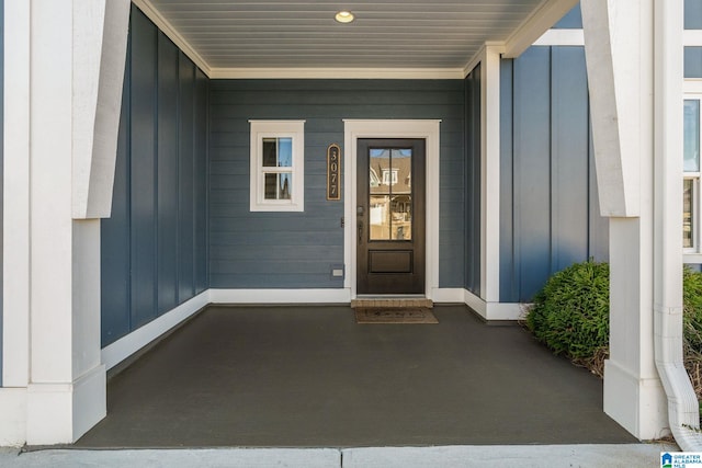 entrance to property with a porch and board and batten siding