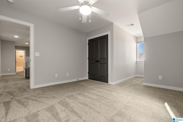 unfurnished bedroom with carpet, visible vents, and baseboards