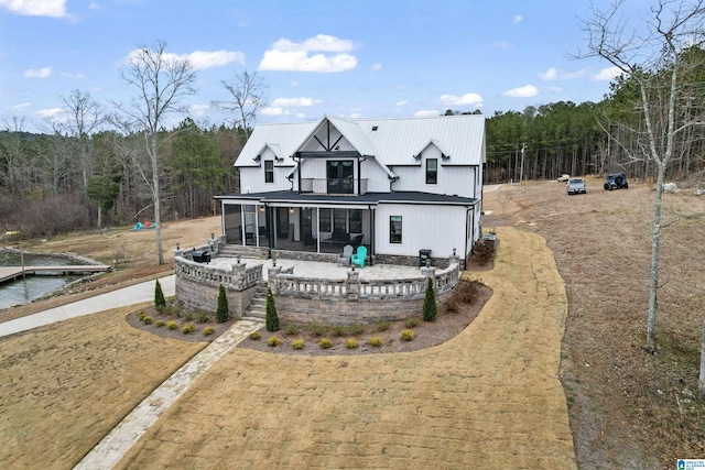 1165 Cedar Creek Dr, Sylacauga, AL 35151 - back of property featuring a sunroom, metal roof, and a balcony
