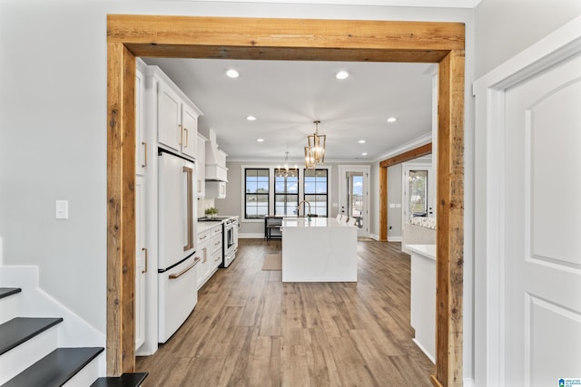 1165 Cedar Creek Dr, Sylacauga, AL 35151 - kitchen with white appliances, white cabinets, light countertops, ornamental molding, and a center island