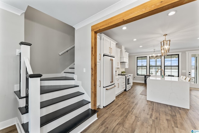 1165 Cedar Creek Dr, Sylacauga, AL 35151 - stairs with a notable chandelier, recessed lighting, ornamental molding, wood finished floors, and baseboards