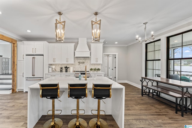 1165 Cedar Creek Dr, Sylacauga, AL 35151 - kitchen with premium range hood, high quality appliances, ornamental molding, backsplash, and an island with sink