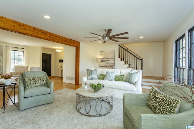 living area with visible vents, wood finished floors, recessed lighting, stairway, and ceiling fan