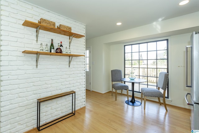 living area with recessed lighting, baseboards, and light wood-style flooring