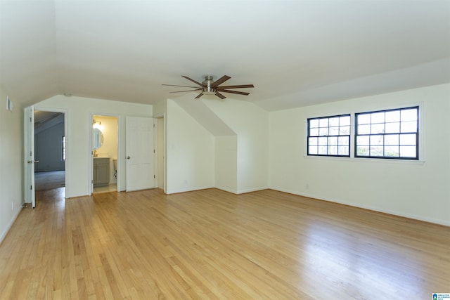 bonus room featuring baseboards, light wood-style floors, and a ceiling fan