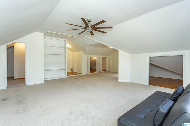 additional living space with a ceiling fan, built in features, carpet, lofted ceiling, and attic access