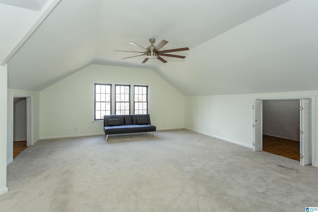 additional living space featuring lofted ceiling, carpet flooring, baseboards, and ceiling fan