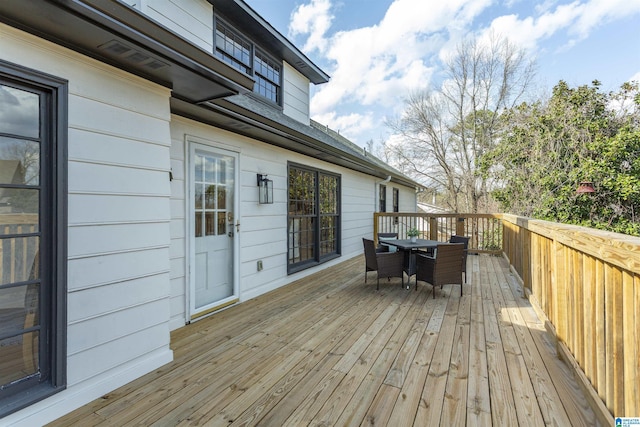 wooden deck featuring outdoor dining space