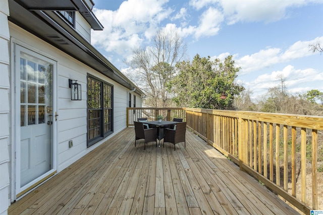 deck featuring outdoor dining area