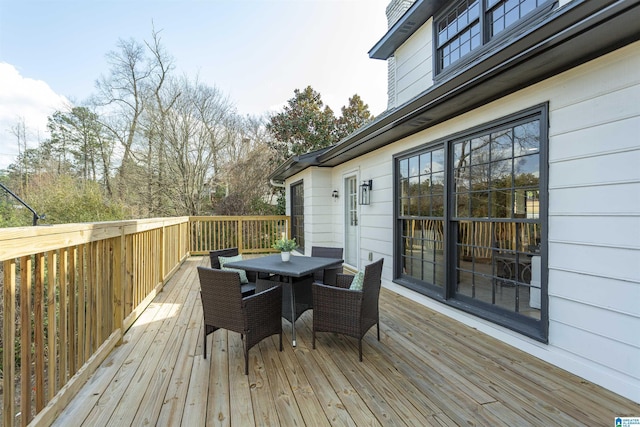 wooden terrace featuring outdoor dining space