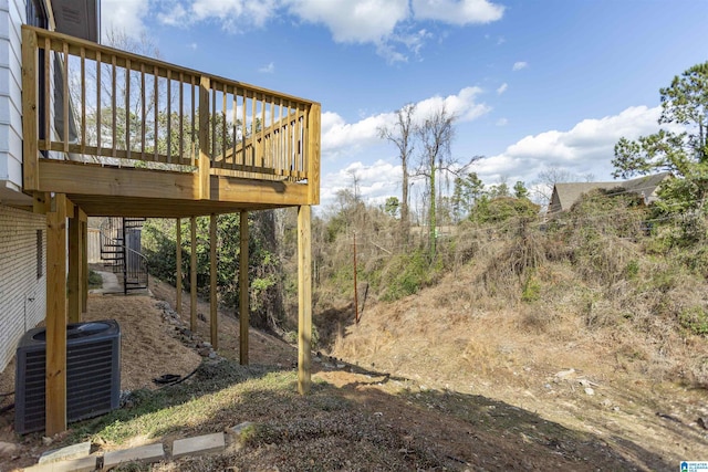 view of yard featuring stairs, a deck, and central AC unit