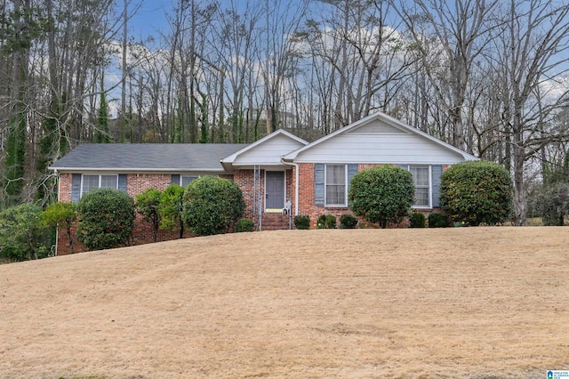 ranch-style home with a front lawn and brick siding