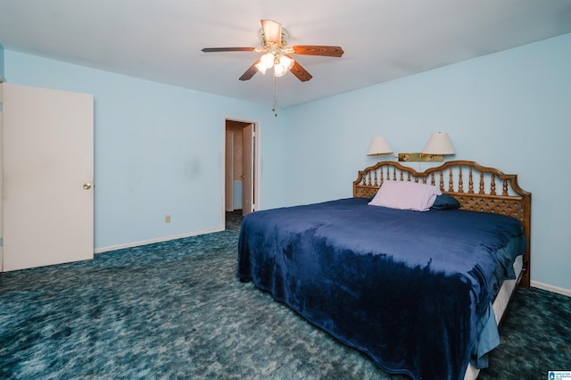 carpeted bedroom with ceiling fan and baseboards