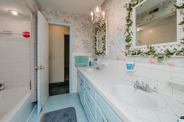 bathroom with a wainscoted wall, visible vents, a sink, and wallpapered walls